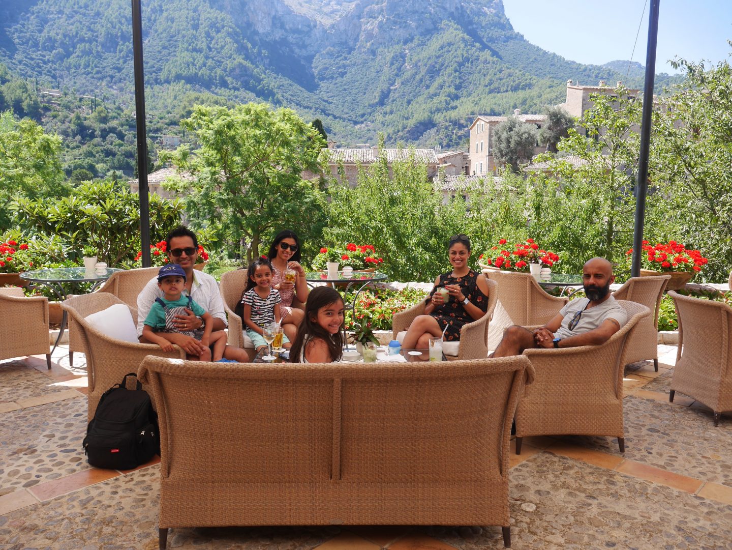 family sat on the straw settee and chairs outside over looking the citrus groves, greenery and hills