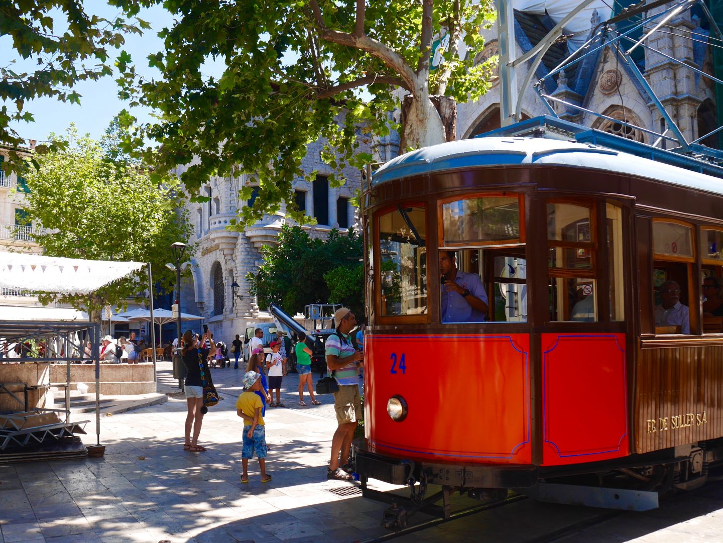 view of a brown and red tram with the number 24 on the front in the centre of Soller Mallorca