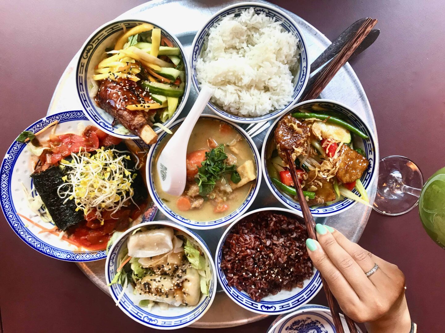 flat lay of 7 different tapas dishes in a circled tray