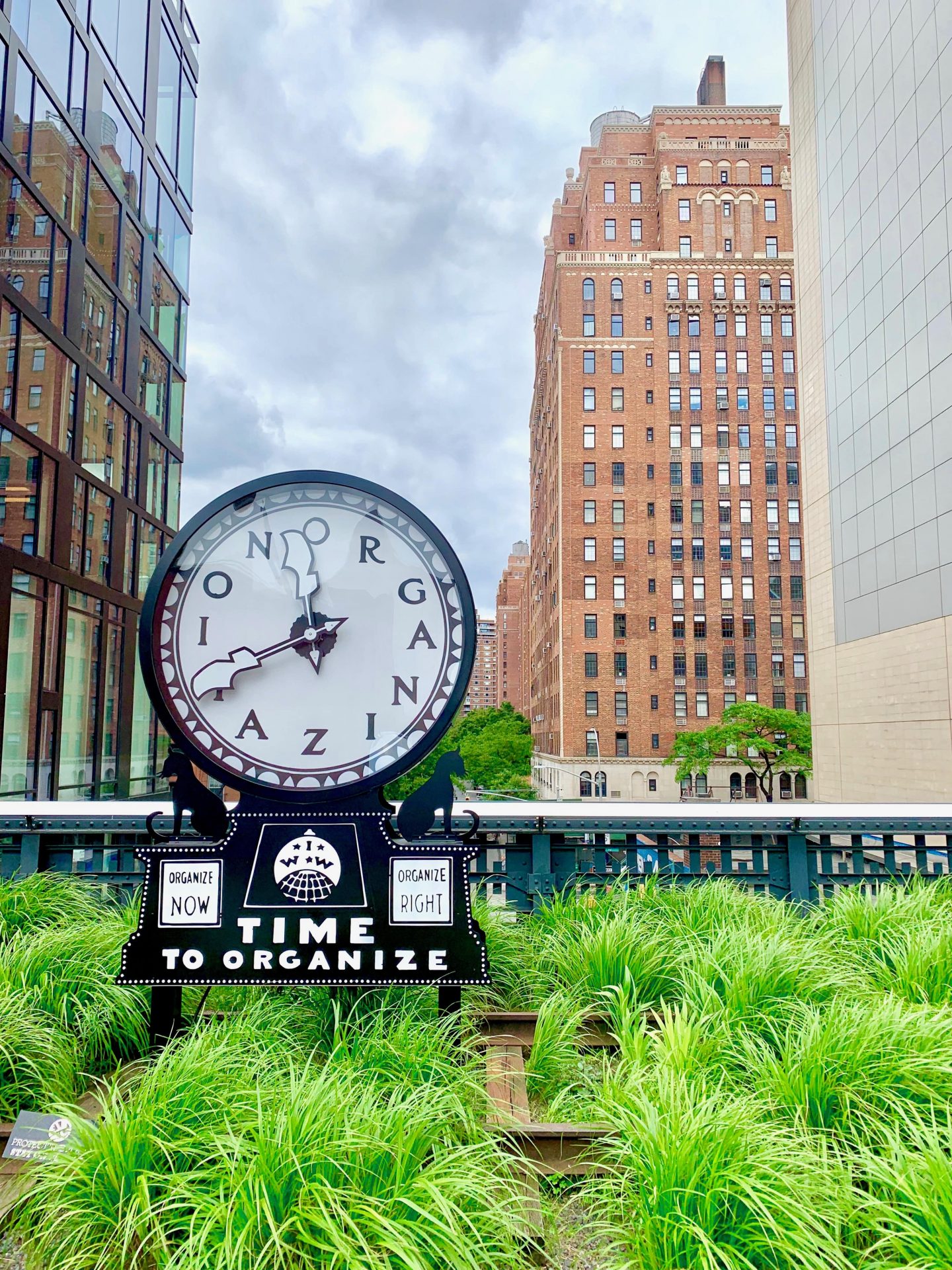 black and white clock on the High Line numbers replaced with the word organization
