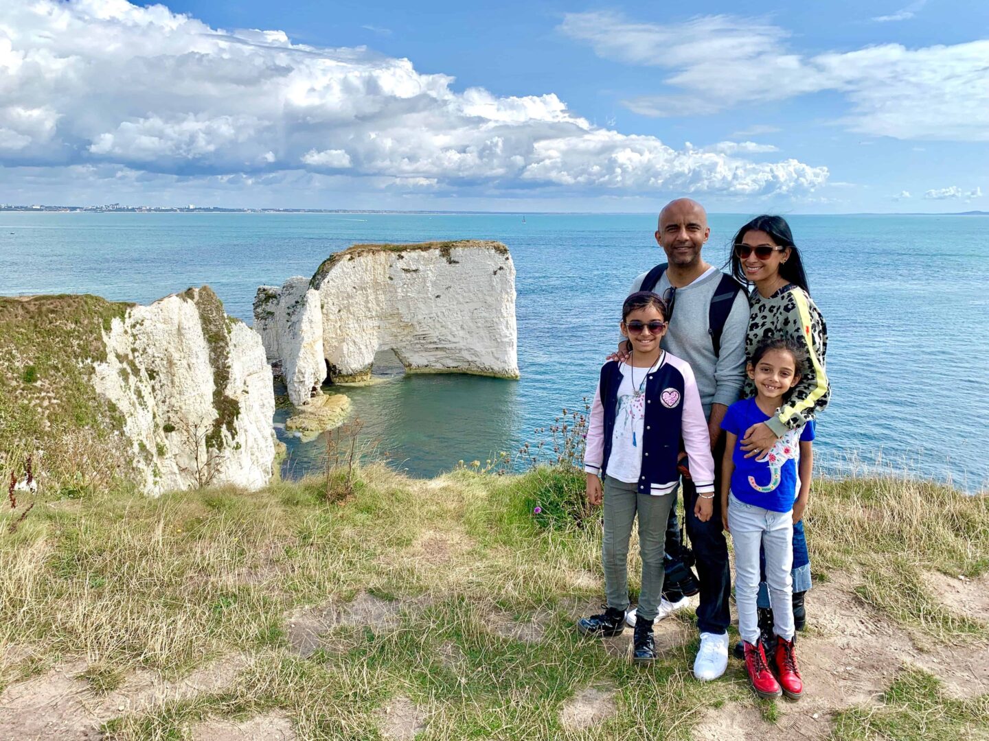 family picture on the cliffs of Dorset overlooking the sea and old harry rocks