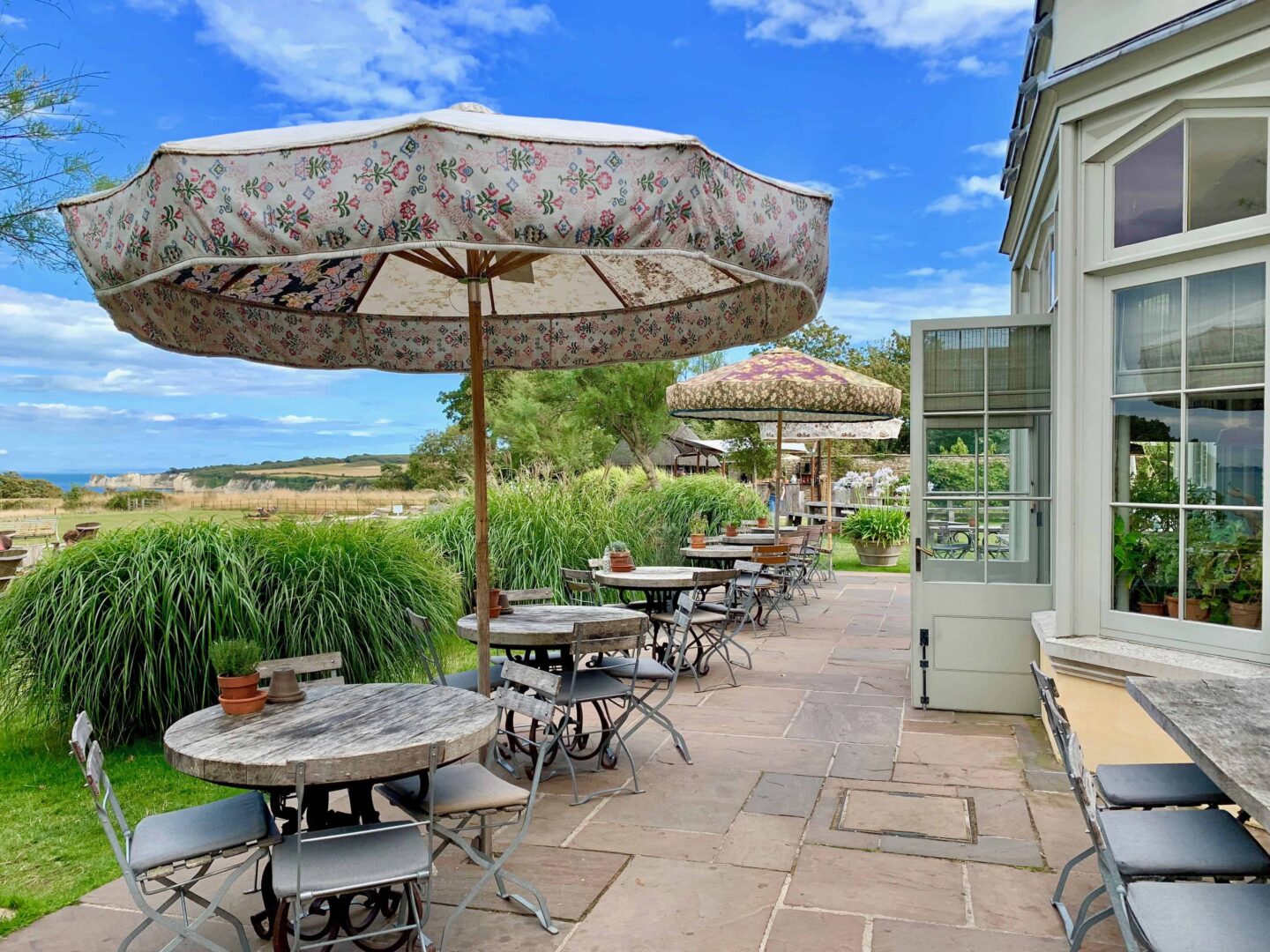 outdoor dining with tables under umbrellas