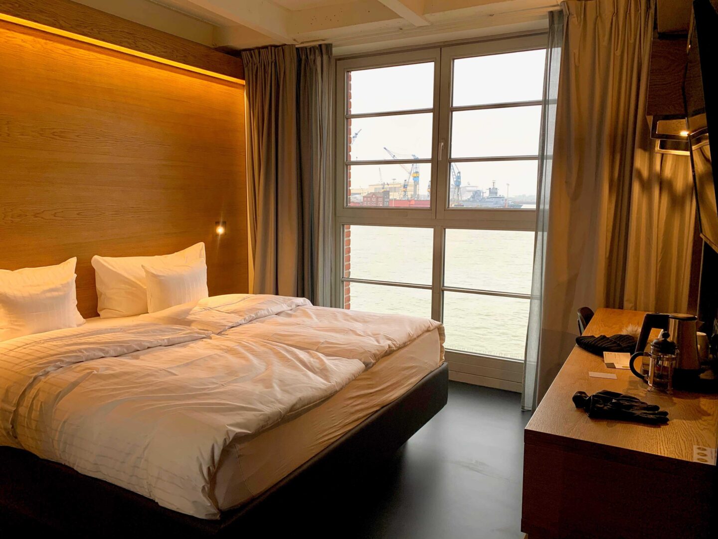 view towards the window overlooking the harbour including double bed and ceiling to floor window