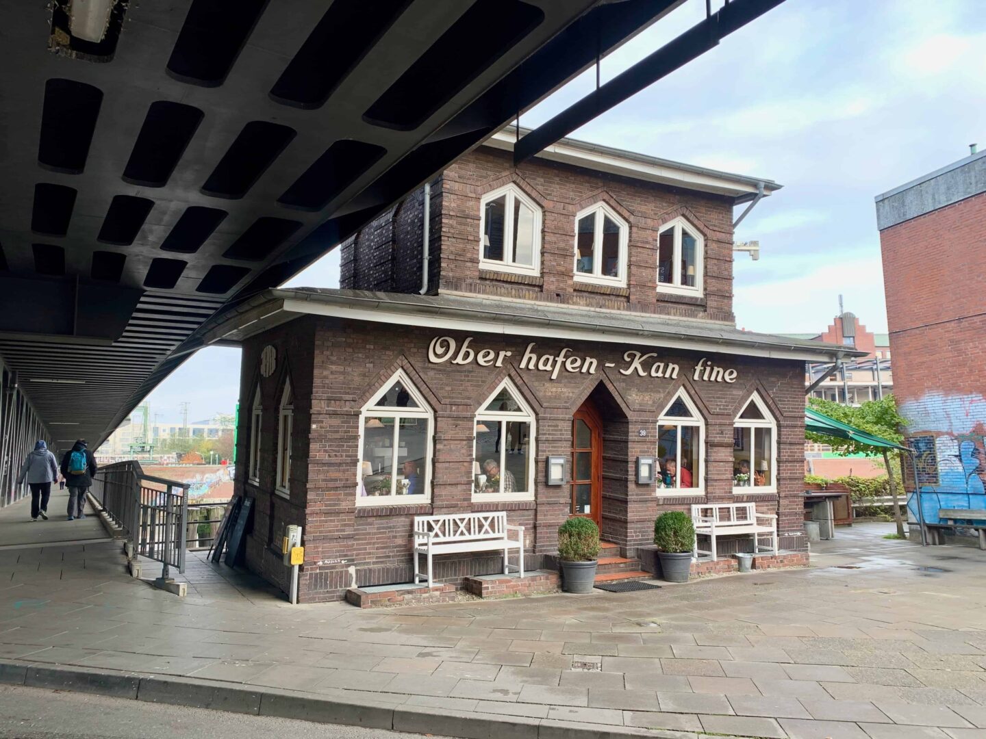 picture of a brick built building part under a bridge named 'over hafen - kan fine'