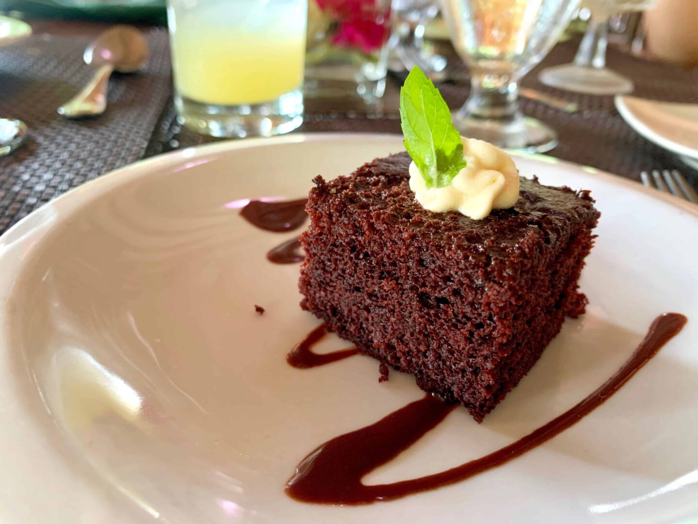 spongy chocolate cake with cream on the top and a green bay leaf?