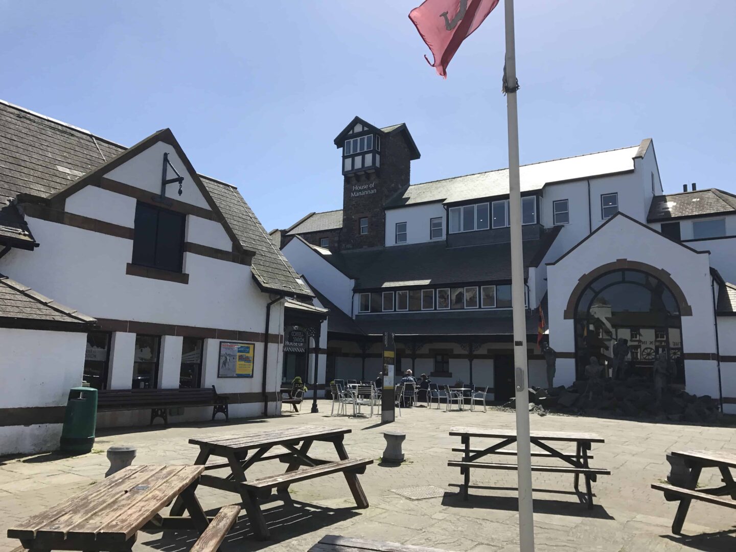 view of the outside black and white painted house of manna on Isle of Man