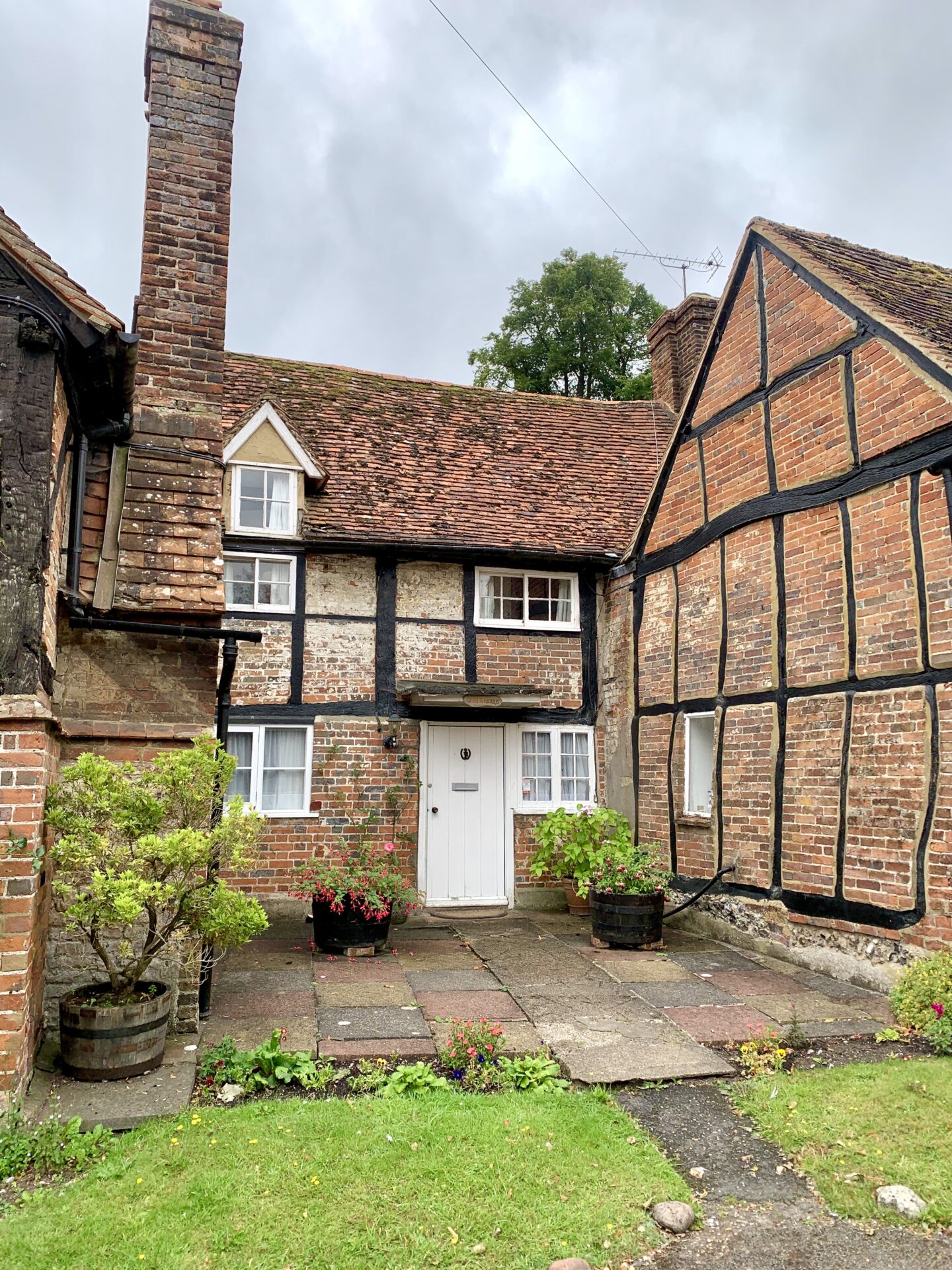 view of an old house with black wooden beams and small which windows