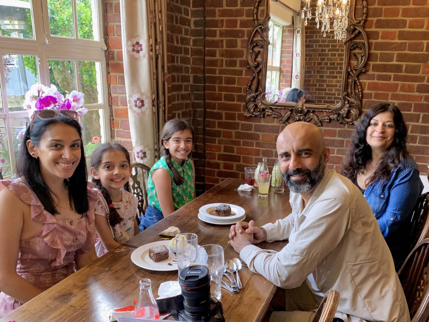 view of family sat at a table eating dessert