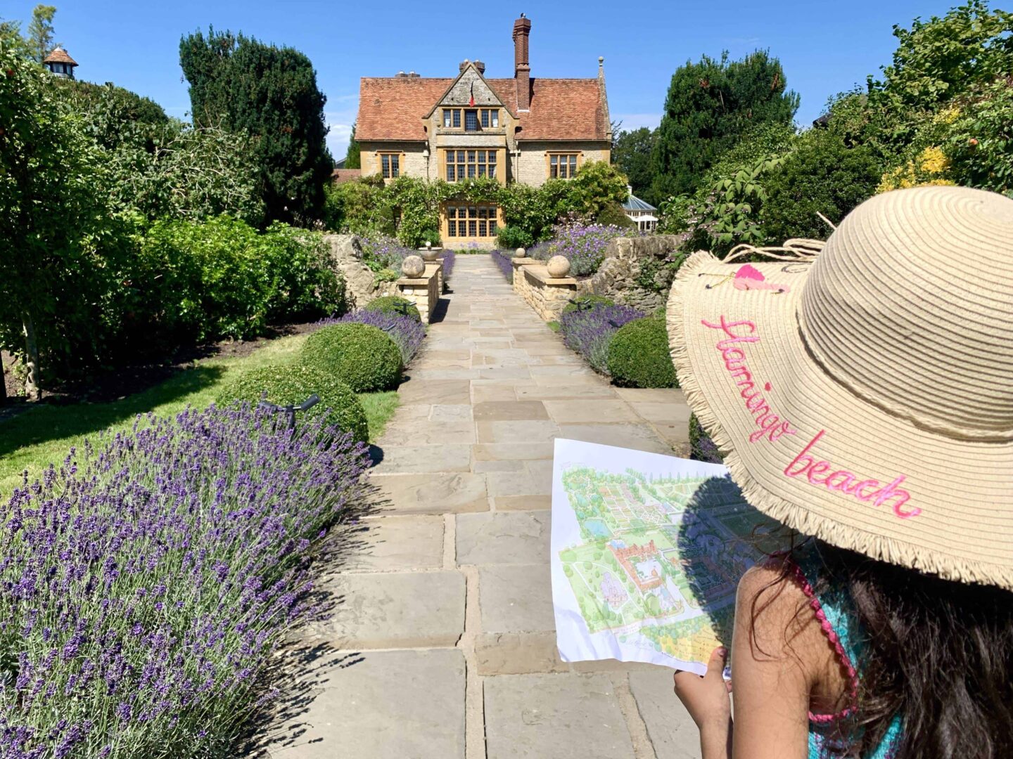 view of simas daughter wearing a start hat 'flamingo beach' looking at a map