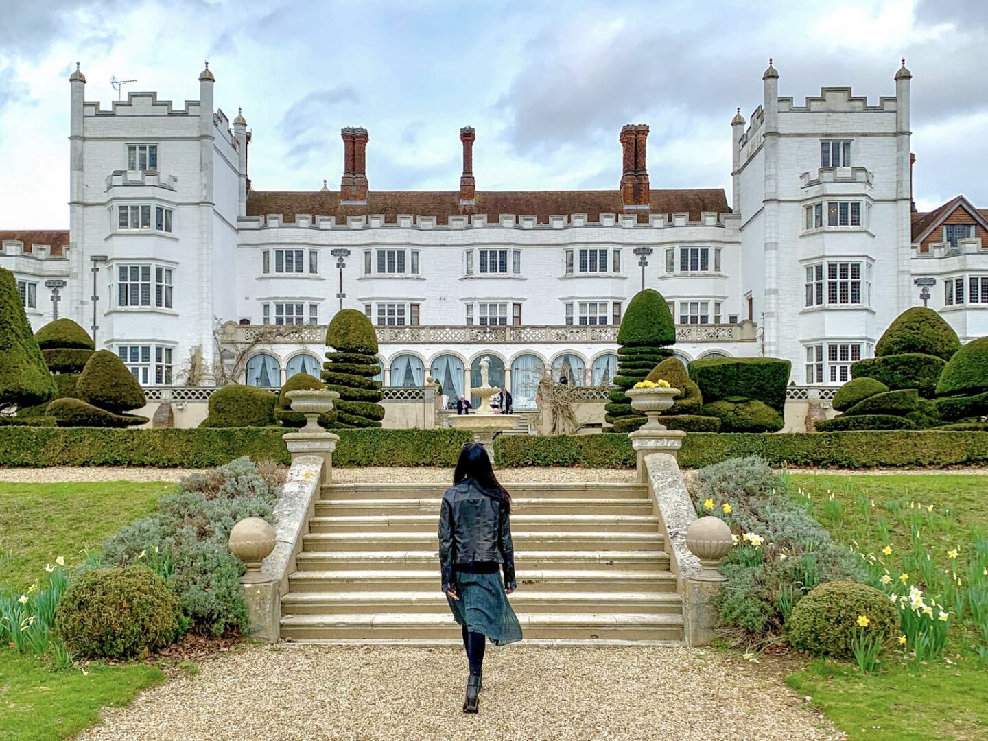 Walking up a grand stately property similar to those featured in Bridgerton.