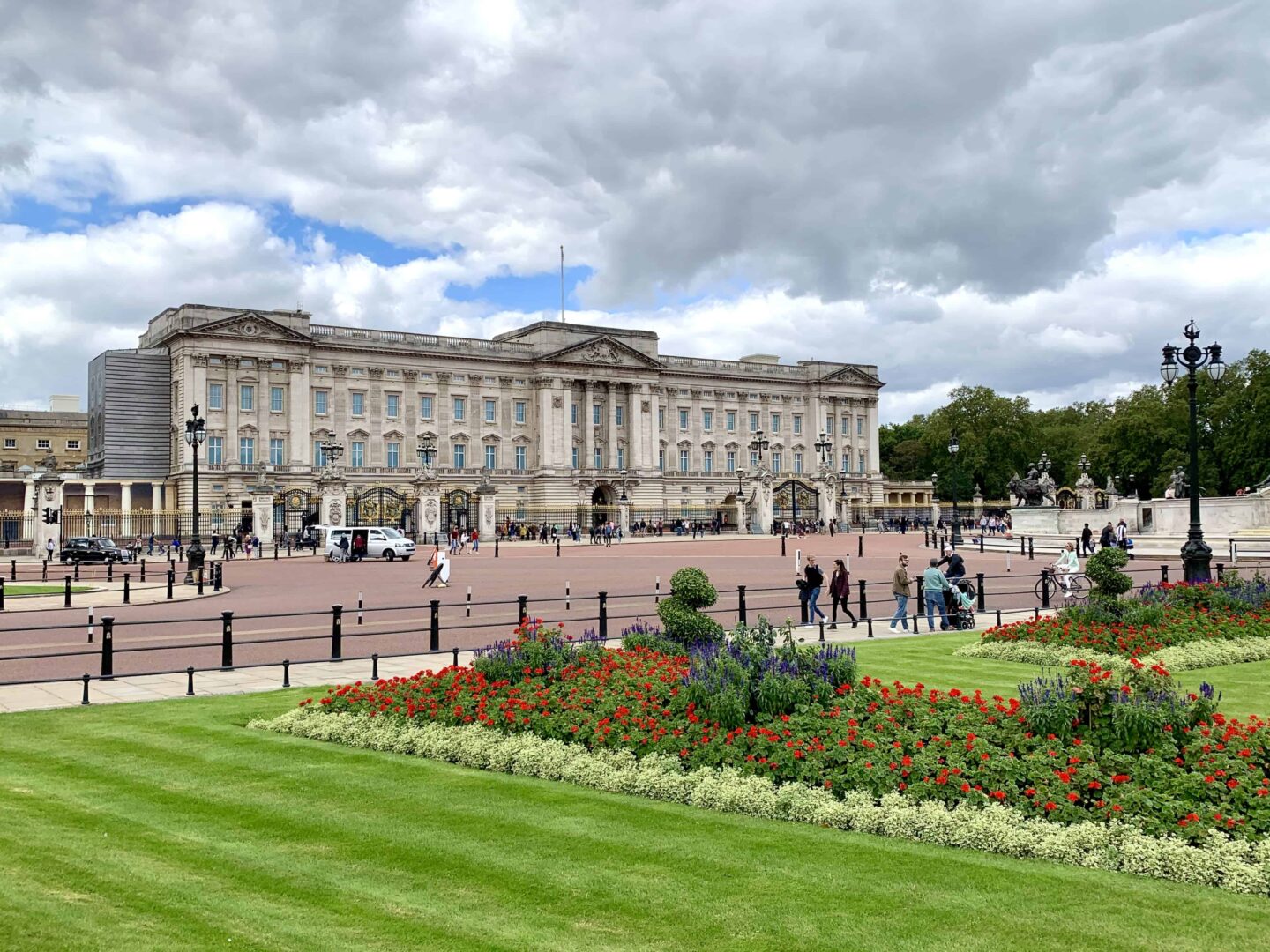 view of Buckingham Palace from the grounds surrounding outside the gates